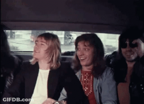 A Group Of People Are Sitting In The Back Of A Car Laughing . GIF