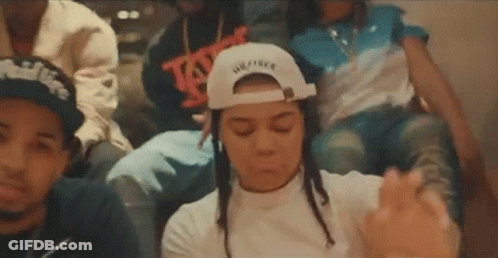 A Group Of People Are Sitting Next To Each Other In A Room . GIF