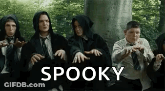 A Group Of People Are Sitting Next To Each Other In Front Of A Tree With The Word Spooky Written On The Bottom . GIF
