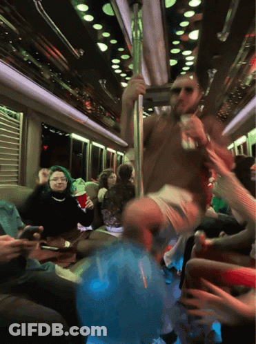 A Group Of People Are Sitting On A Bus And One Of Them Is Holding A Red Cup GIF