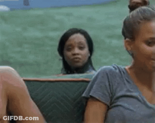A Group Of People Are Sitting On A Couch And One Woman Is Looking At The Camera . GIF