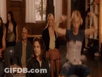 A Group Of People Are Sitting On A Couch In A Living Room . GIF