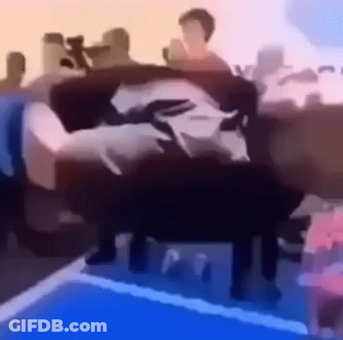 A Group Of People Are Sitting On A Couch . GIF