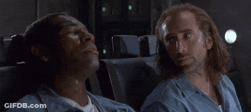 A Group Of People Are Sitting On A Plane And One Of Them Is Wearing A White Shirt GIF