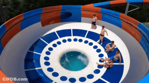 A Group Of People Are Sitting On Top Of A Water Slide That Looks Like An Eye GIF