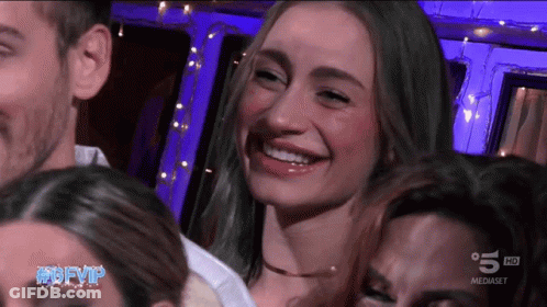 A Group Of People Are Smiling In Front Of A Screen That Says 5 Hd On It GIF
