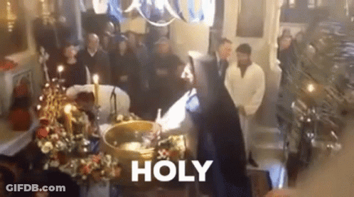 A Group Of People Are Standing Around A Coffin In A Church With The Word Holy Written On The Bottom . GIF