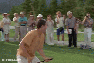 A Group Of People Are Standing Around A Golf Course Watching A Man Play Golf . GIF