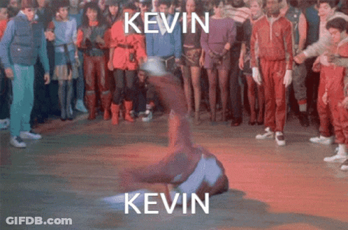 A Group Of People Are Standing Around A Man Doing A Trick With The Name Kevin Written Above Him GIF
