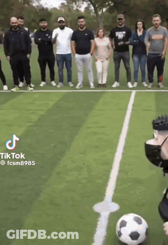 A Group Of People Are Standing Around A Soccer Ball On A Field With Tiktok Written On The Bottom GIF
