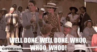 A Group Of People Are Standing Around A Table With The Words Well Done Well Done Whoo Whoo Whoo Written On Them . GIF