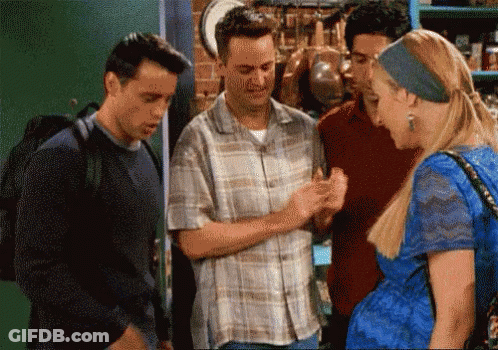 A Group Of People Are Standing Around A Woman In A Blue Dress And Talking To Each Other . GIF