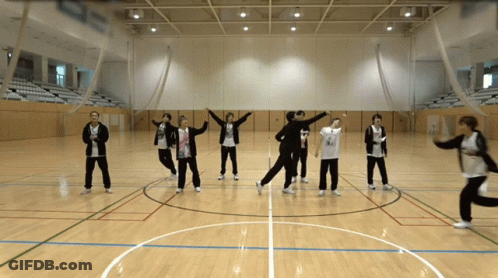 A Group Of People Are Standing In A Circle On A Court GIF