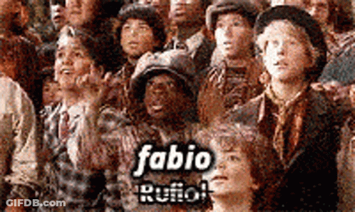 A Group Of People Are Standing In A Crowd With The Name Fabio Rufo On The Bottom GIF