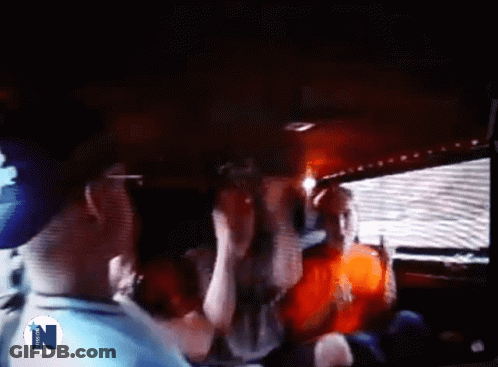 A Group Of People Are Standing In A Dark Room With The Letter N On The Bottom Right GIF