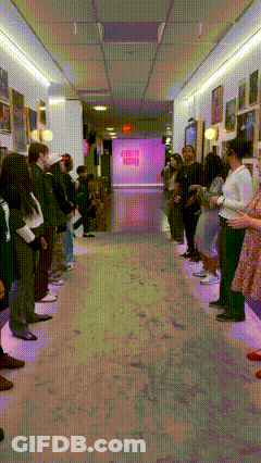 A Group Of People Are Standing In A Hallway In Front Of A Sign That Says ' Sleep ' GIF