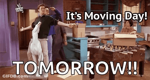 A Group Of People Are Standing In A Kitchen With Boxes And A Sign That Says It 'S Moving Day Tomorrow ! GIF