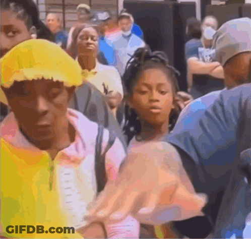 A Group Of People Are Standing In A Line Including A Girl Wearing A Yellow Hat GIF