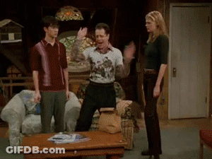 A Group Of People Are Standing In A Living Room And One Of Them Is Wearing A Shirt That Says ' I Love You ' GIF