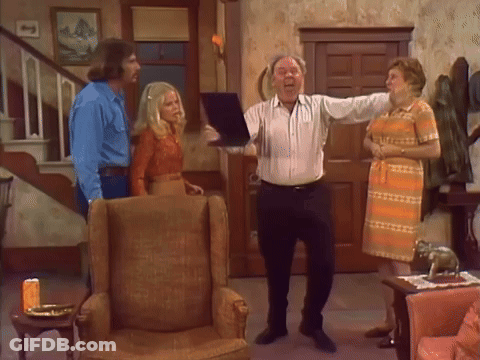 People Standing In Living Room With Man Holding Paper GIF