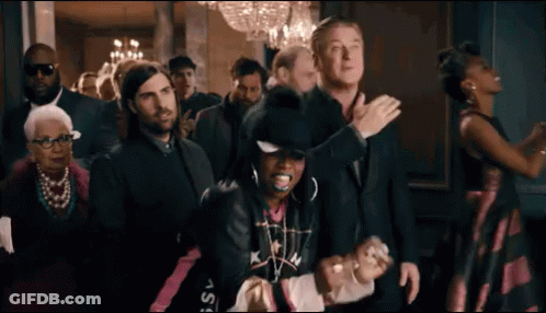 A Group Of People Are Standing In A Room And Dancing . GIF