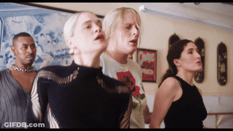 A Group Of People Are Standing In A Room And One Of Them Has A T-Shirt That Says " I Love You " GIF