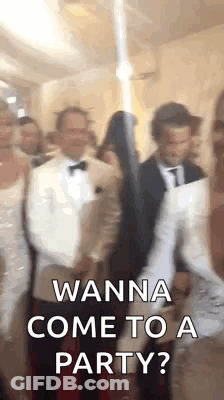 A Group Of People Are Standing In A Room And One Of Them Is Holding A Sword . GIF