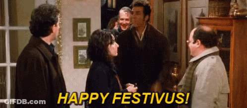 A Group Of People Are Standing In A Room And One Of Them Is Saying Happy Festivus ! GIF