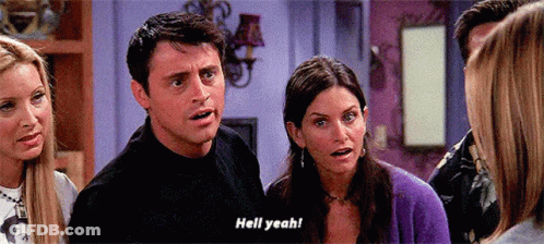 A Group Of People Are Standing In A Room And One Of Them Is Saying " Hell Yeah " GIF