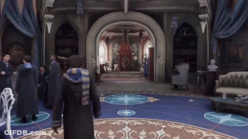A Group Of People Are Standing In A Room With A Blue Floor GIF
