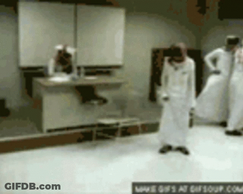A Group Of People Are Standing In A Room With A Sign That Says ' Www.gifsoup.com ' On The Bottom GIF