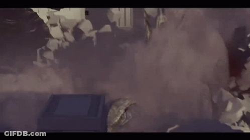 A Group Of People Are Standing In A Room With Smoke Coming Out Of The Walls . GIF