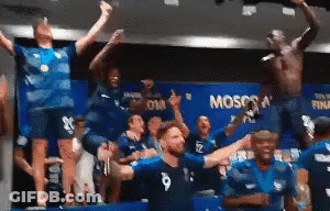 A Group Of People Are Standing In A Room With The Word Moscow On The Wall . GIF