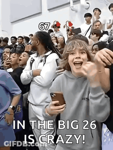 A Group Of People Are Standing In A Room With The Words In The Big 26 Is Crazy Written On The Bottom GIF