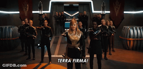 A Group Of People Are Standing In A Room With The Words Terra Firma On The Floor GIF