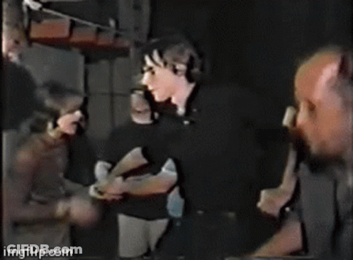 Group Of People Standing With Weezer Text GIF