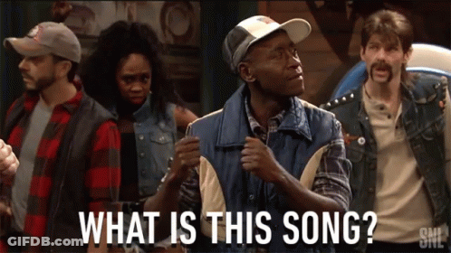 A Group Of People Are Standing In A Room With The Words What Is This Song GIF