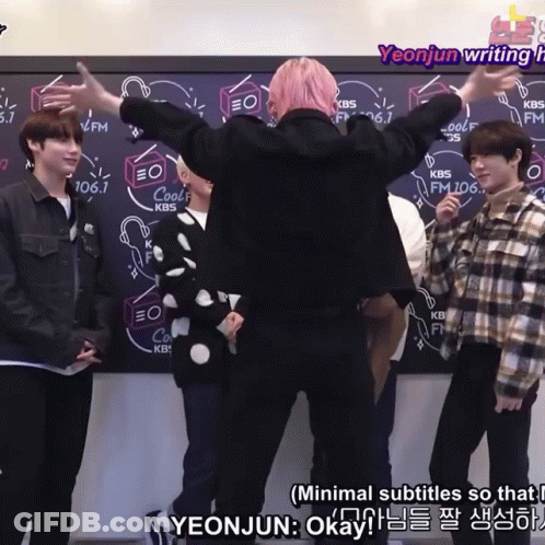 A Group Of People Are Standing In Front Of A Blackboard With Kbs Written On It GIF