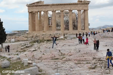 A Group Of People Are Standing In Front Of A Building With The Word Athens On It GIF