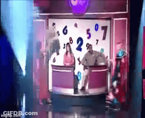 A Group Of People Are Standing In Front Of A Display Of Numbers GIF