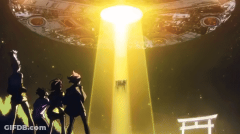 A Group Of People Are Standing In Front Of A Large Object With A Light Coming From It GIF
