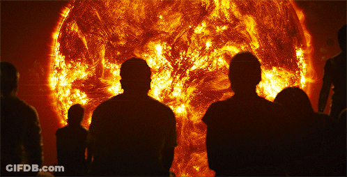 A Group Of People Are Standing In Front Of A Large Sun GIF