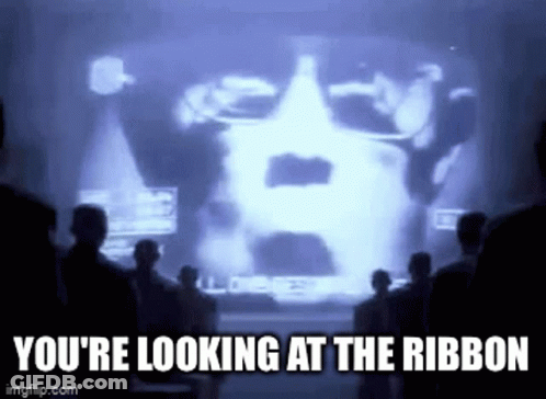 A Group Of People Are Standing In Front Of A Screen That Says You 'Re Looking At The Ribbon . GIF