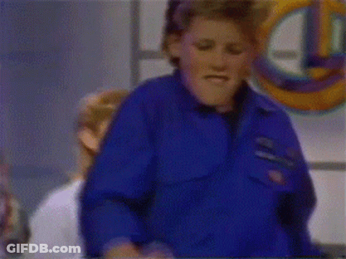 A Group Of People Are Standing In Front Of A Sign That Says ' A & N Quiz ' GIF