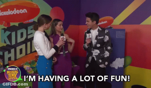 A Group Of People Are Standing In Front Of A Sign That Says Kids Choice GIF
