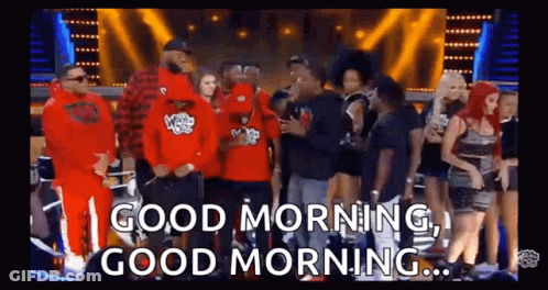 A Group Of People Are Standing In Front Of A Stage And A Sign That Says `` Good Morning , Good Morning '' . GIF