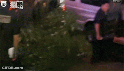 A Group Of People Are Standing In Front Of A Van And Talking To Each Other . GIF
