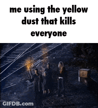 A Group Of People Are Standing In Front Of Train Tracks And Using The Yellow Dust That Kills Everyone . GIF