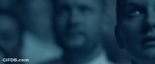 A Group Of People Are Standing Next To Each Other And Looking Up At Something . GIF
