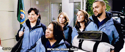 A Group Of People Are Standing Next To Each Other And One Of Them Is Holding A Bag And Saying We 'Re The Dream Team GIF